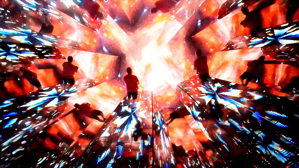 Red and blue mirror room with a man standing in the middle