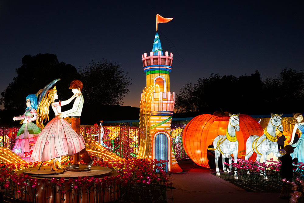 A lighted version of Aurora and her Prince dancing with a lighted castle in the background.