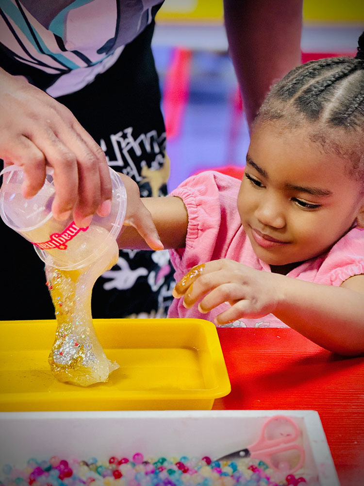 Imaginarium Slime Time Lab Young Black Girl Playing with Clear Sparkly Slime